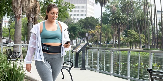 Woman Walking with Abs Electro Stimulator